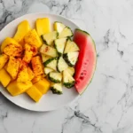 Platter of exotic fruits dusted with Tajín powder.