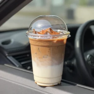 A steaming mug of vegan pumpkin spice coffee topped with dairy-free foam and a sprinkle of cinnamon on a cozy autumn table